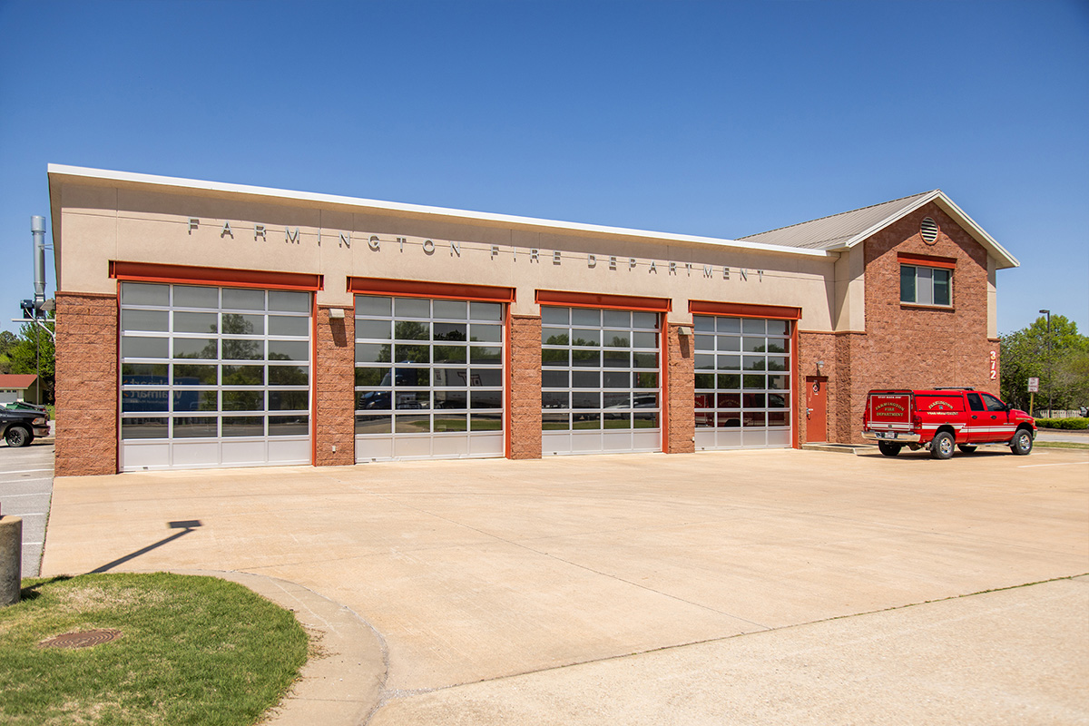 Exterior view of a modern Modern Farmington Fire Department with large garage doors