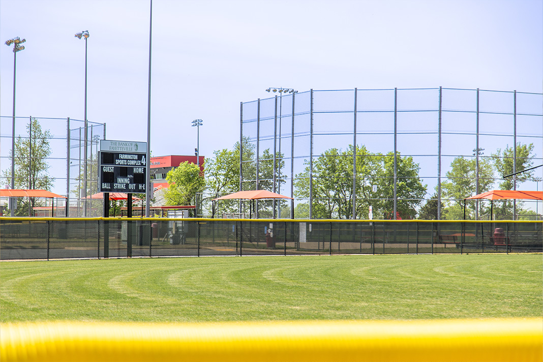 Baseball field in Farmington sports complex with a vibrant green outfield and scoreboard 